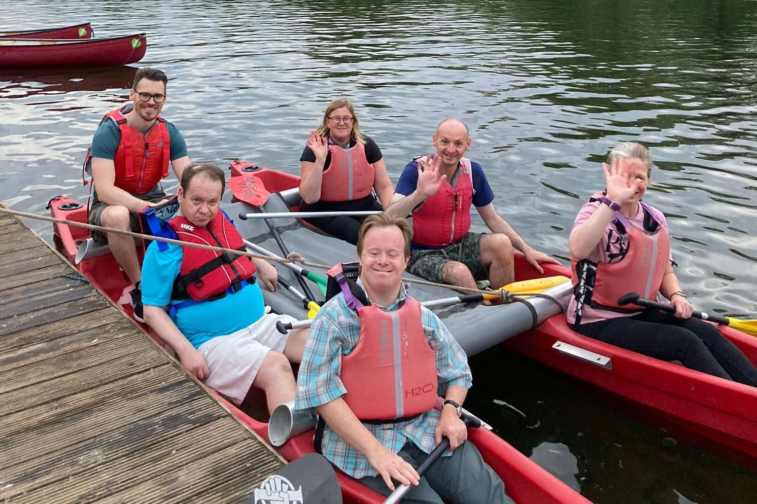 Six adults are sitting in a katakanu