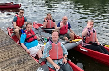 Six adults are sitting in a katakanu
