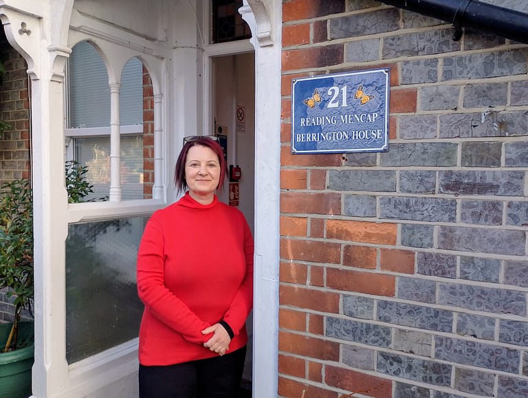 Sally Utting is standing in the front doorway of Reading Mencap.