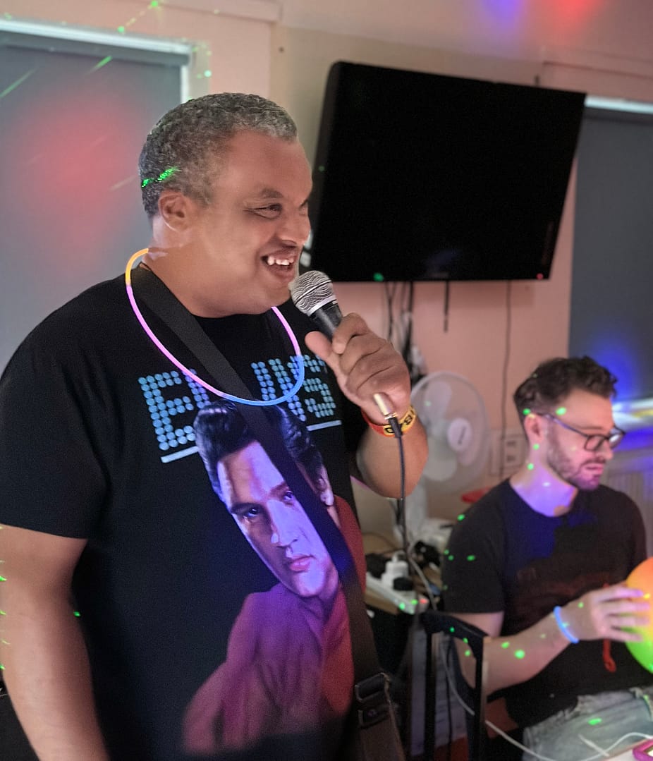 A man is holding a microphone and singing